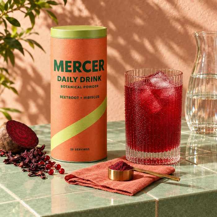 Water and a ruby drink next to the Mercer canister