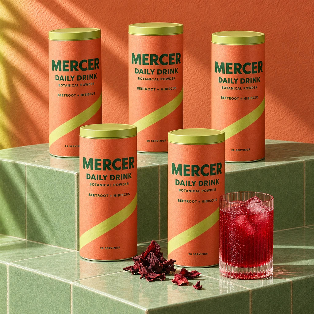 Five Mercer Daily Drink canisters arranged on tiled steps